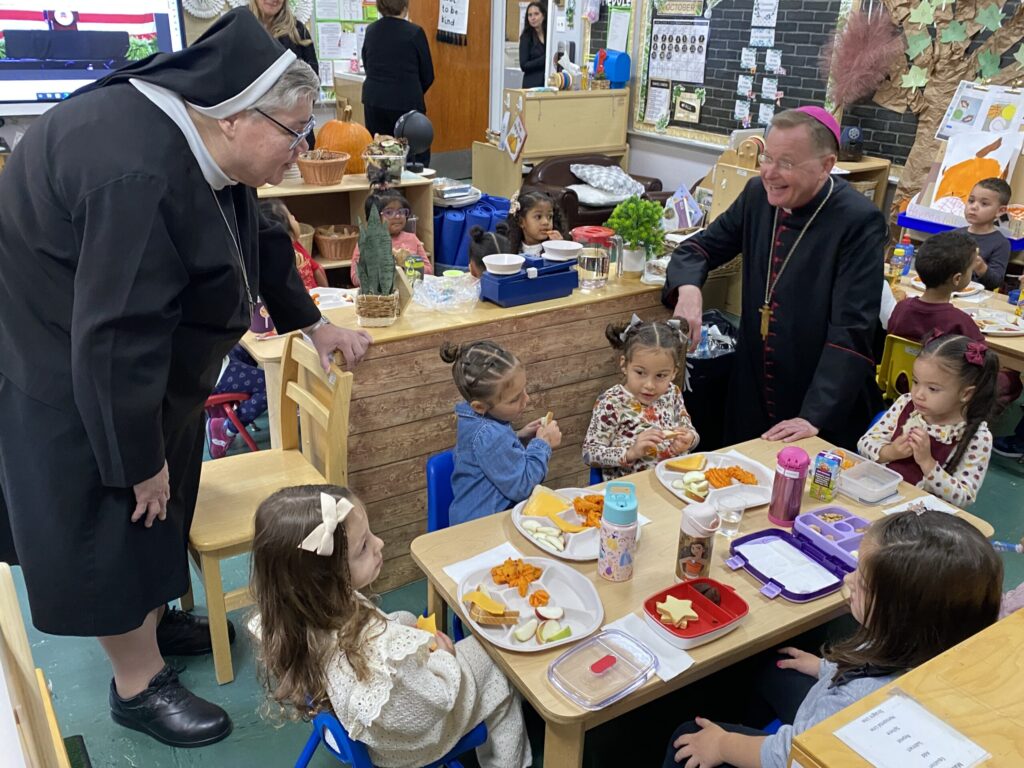 Auxiliary Bishop Edmund Whalen (right) and Sister Mary Grace Walsh, ASCJ, Ph.D., Superintendent of Schools, visit with prekindergarten students of St. Theresa School in the Bronx, October 17, 2023.