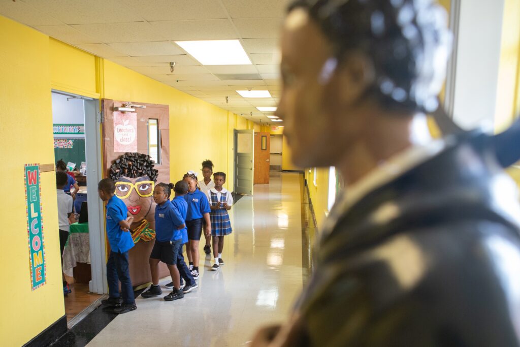 Students at St. Mary of the Purification Montessori School in Houston walk by a statue of St. Martin de Porres on August 14, 2019, during their first day of school. The school is recognized as the only Montessori school for African Americans in Texas.