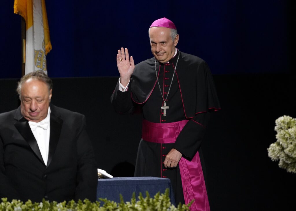 Archbishop Gabriele Caccia, the Vatican's permanent observer to the United Nations, waves as he arrives on the dais during the 77th annual Alfred E. Smith Memorial Foundation Dinner at the Park Avenue Armory in New York City Oct. 20, 2022.