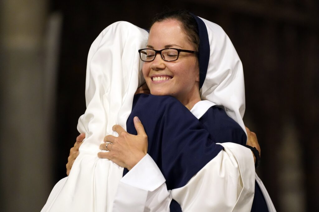 Sister Zelie Maria Louis smiles as she is embraced by a fellow Sister of Life after she and six other members of the religious community professed their perpetual vows during a special Mass at St. Patrick’s Cathedral in New York City August 5, 2023.