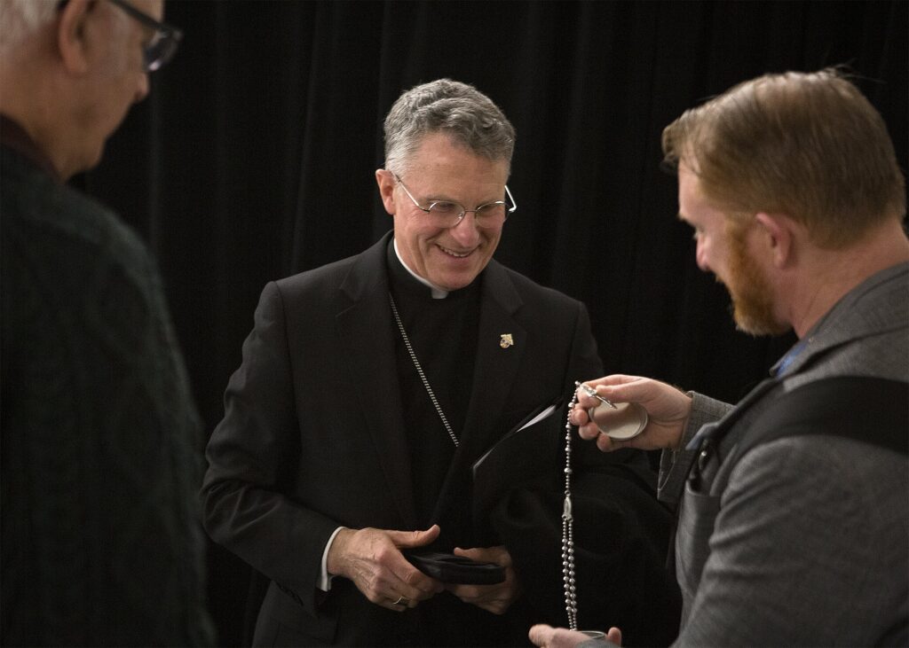 A U.S. Army veteran asks Archbishop Timothy P. Broglio of the U.S. Archdiocese for the Military Services to bless a rosary after morning Mass January 27, 2020, during the Catholic Social Ministry Gathering in Washington.