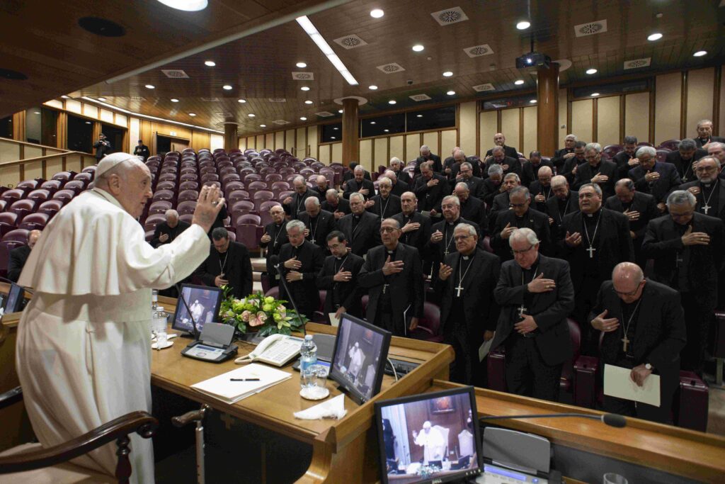 Pope Francis gives his blessing to the bishops of Spain after a two-hour meeting with them in the Vatican synod hall on November 28, 2023.