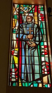 Fr. Hecker in stained glass at St. Paul's in LA 2022 photo by Chris Malano