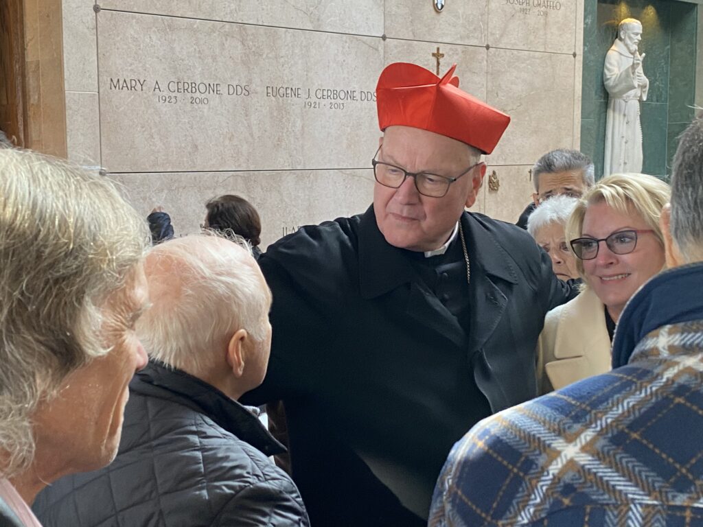 Cardinal Timothy Dolan (center) greets well-wishers after Mass at Gate of Heaven Cemetery's Queen of Heaven Mausoleum in Hawthorne, November 2, 2023.