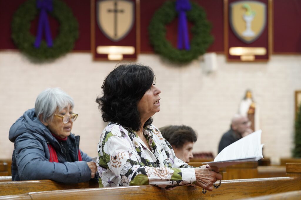 Women pray during eucharistic adoration at St. Matthew Church in Dix Hills, on December 8, 2022.