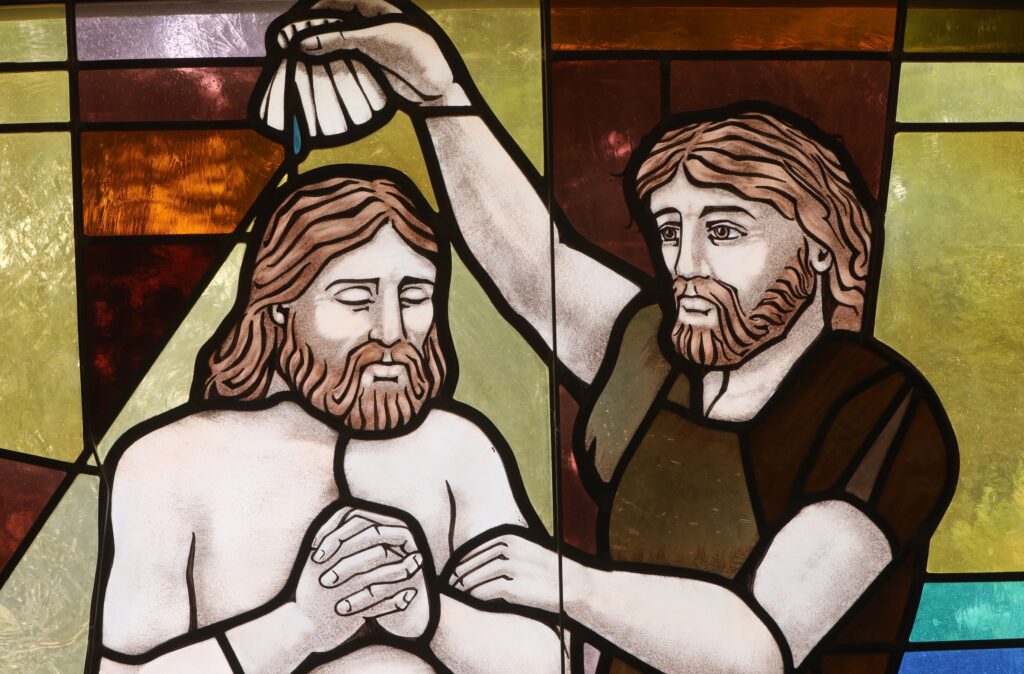 The baptism of Christ by John the Baptist is depicted in a stained glass window at St. Anthony's Church in North Beach, Maryland, in this file photo dated July 15, 2021.