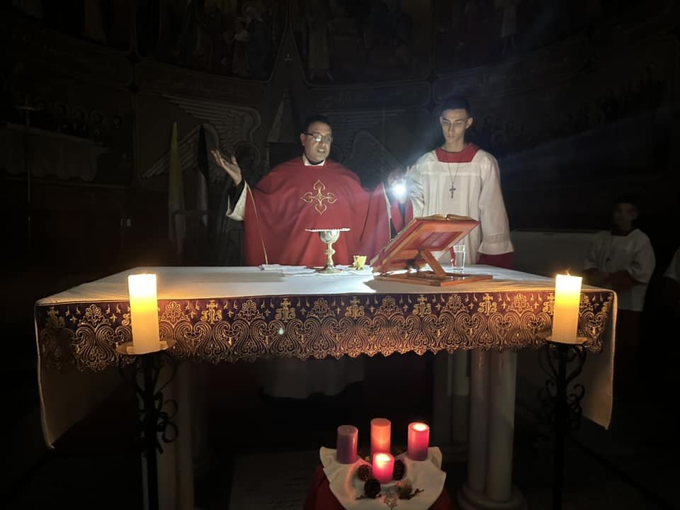 Father Youssef Asaad celebrates the Divine Liturgy in Holy Family Church in Gaza City December 13, 2023.