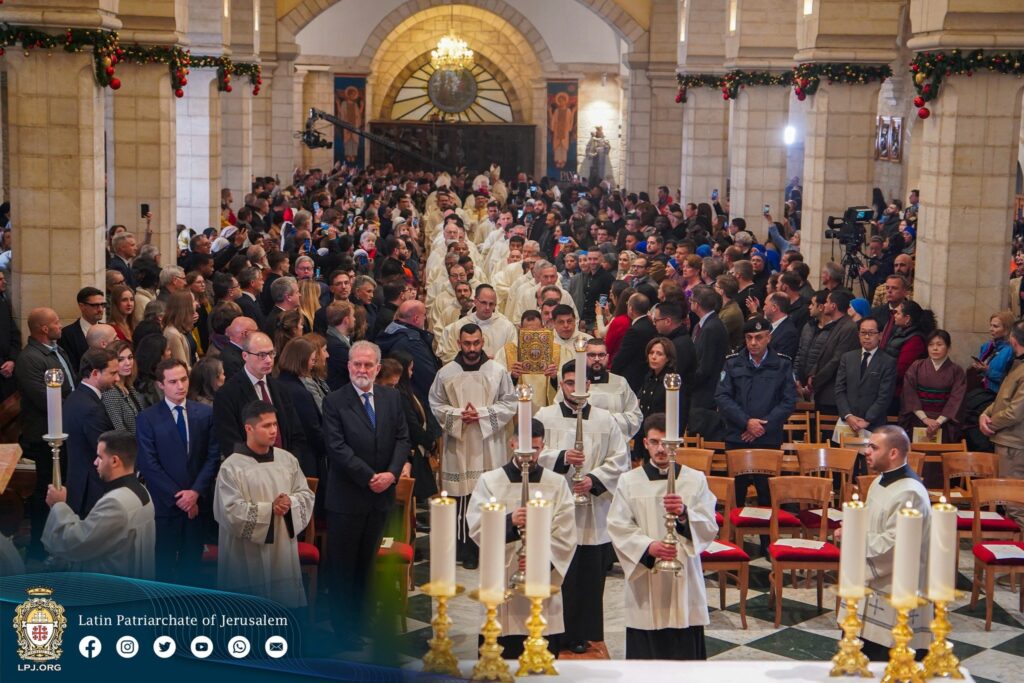 Latin Patriarch of Jerusalem Cardinal Pierbattista Pizzaballa and Cardinal Konrad Krajewski, prefect of Vatican Dicastery for the Service of Charity, participate in a procession at the beginning of Mass at the Church of the Nativity in Bethlehem, on the West Bank, on December 24, 2023. Cardinal Krajewski arrived in the Holy Land on December 22 to be present to Palestinian Christians during Christmas amid the ongoing Israel-Hamas war.