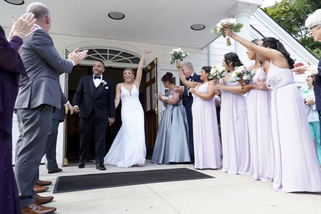 Julio Prendergast and Christina MacDougall are all smiles as they exit St. John the Baptist Church in Wading River, following their wedding Mass August 20, 2021.