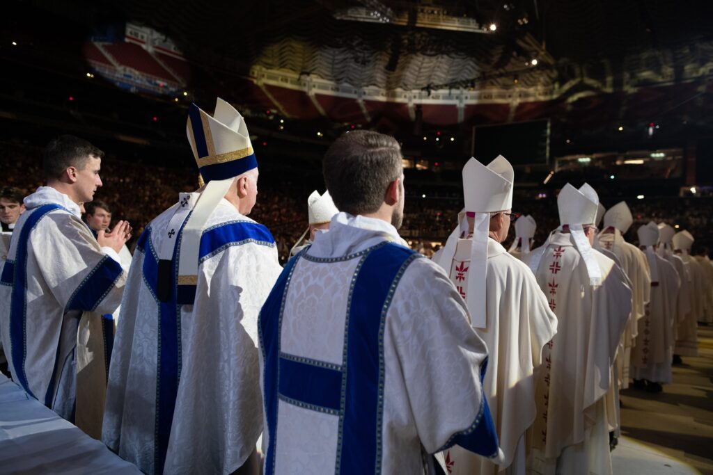 St. Louis Archbishop Mitchell T. Rozanski, second from right, and dozens of bishops and clergy process at the start of Mass on January 1, 2024, during the SEEK24 conference at America's Center Convention Complex in St. Louis. Nearly 20,000 participants attended the January 1-5 conference held by the Fellowship of Catholic University Students.