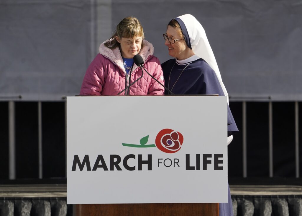 Casey Gunning, an athlete in the Special Olympics, speaks as her twin, Sister of Life Mary Casey, looks on during the 50th annual March for Life in Washington January 20, 2023.