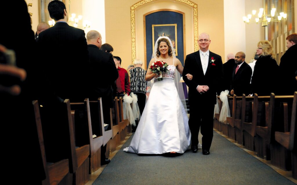 Lisa Coia and Alan Bubel process out of Our Mother of Sorrows Church in Greece, N.Y., at the end of their wedding ceremony in 2008.