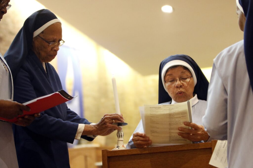 A file photo shows Sister Mary Ann Baichan, center, professing first vows during a Mass in 2016 during the centennial year of the founding of the Franciscan Handmaids of the Most Pure Heart of Mary at St. Charles Borromeo Church in the Harlem section of New York City.