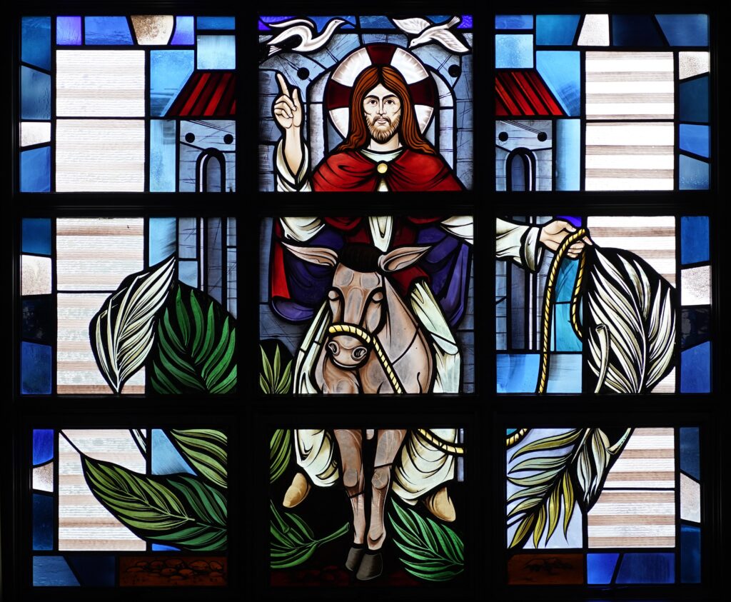 Christ's entry into Jerusalem prior to his crucifixion is depicted in a stained-glass window at Assumption of the Blessed Virgin Mary Church in Centereach.