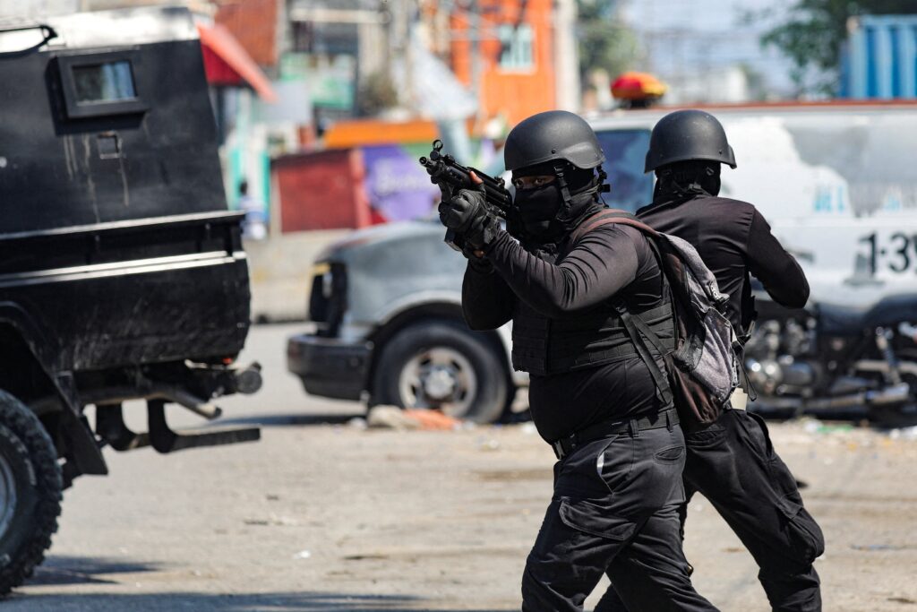 Police officers take part in an operation on the surroundings of the National Penitentiary following a fire in Port-au-Prince, Haiti, March 14, 2024, as a powerful gang leader in Haiti has issued a threatening message aimed at political leaders who would take part in a still-unformed transition council for the impoverished country.