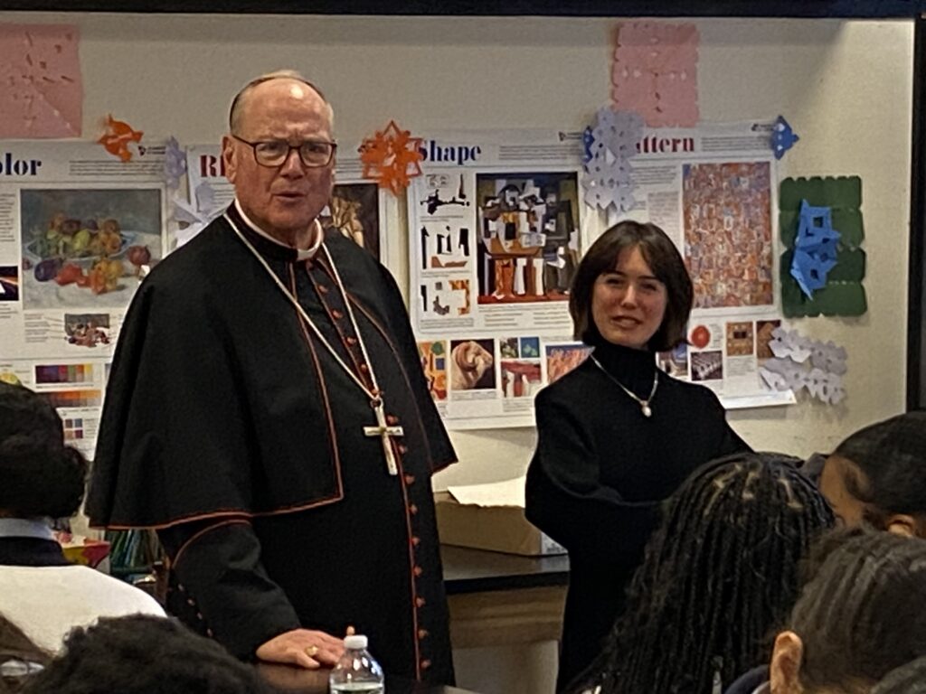 Cardinal Timothy Dolan (left) talks with the students of art teacher Isabella Parker at Cathedral High School's new premises on East 97th Street in Manhattan on Wednesday, March 6, 2024.