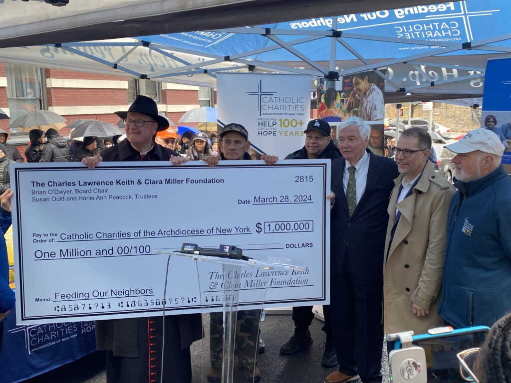 Cardinal Timothy Dolan (left, wearing black hat) received a $1 million donation on behalf of Catholic Charities of the Archdiocese of New York from the Charles Lawrence Keith and Clara Miller Foundation, represented by Brian O'Dwyer (third right).