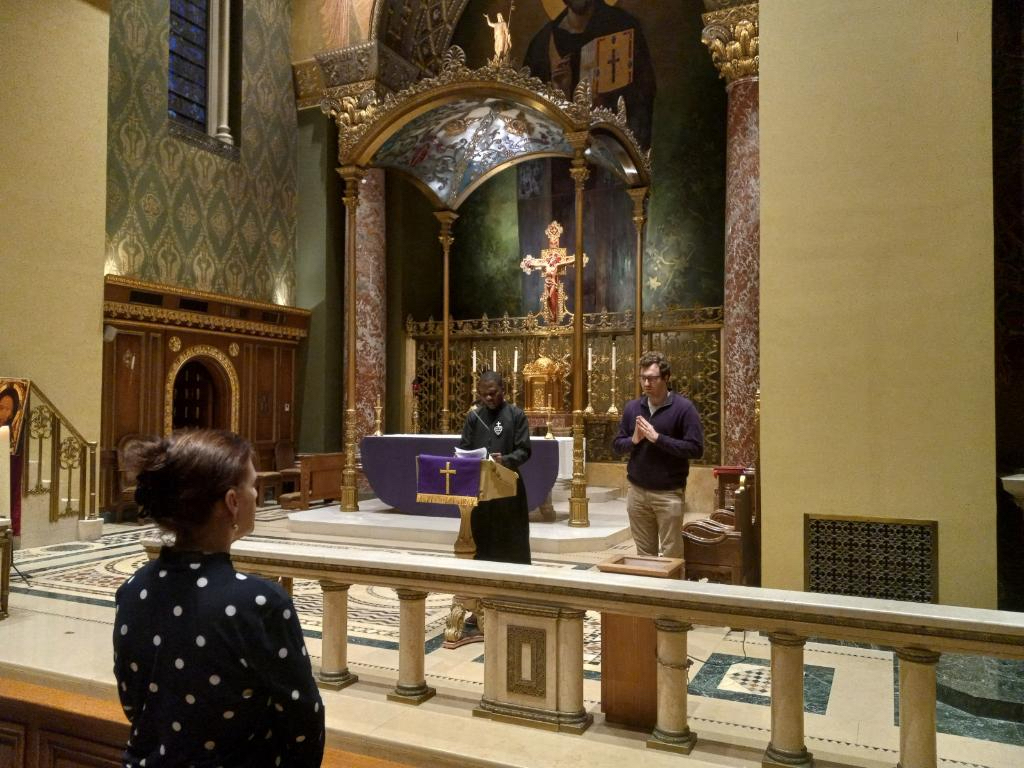 Daniel Cadet, a Haitian-born, Passionist seminarian based in Queens, reads from the Gospel of John during a Prayer Service for Peace in Haiti, at Church of Our Saviour in Manhattan. Behind him is Jeremy Faust, a staffer at the Permanent Mission of the Holy See to the United Nations.