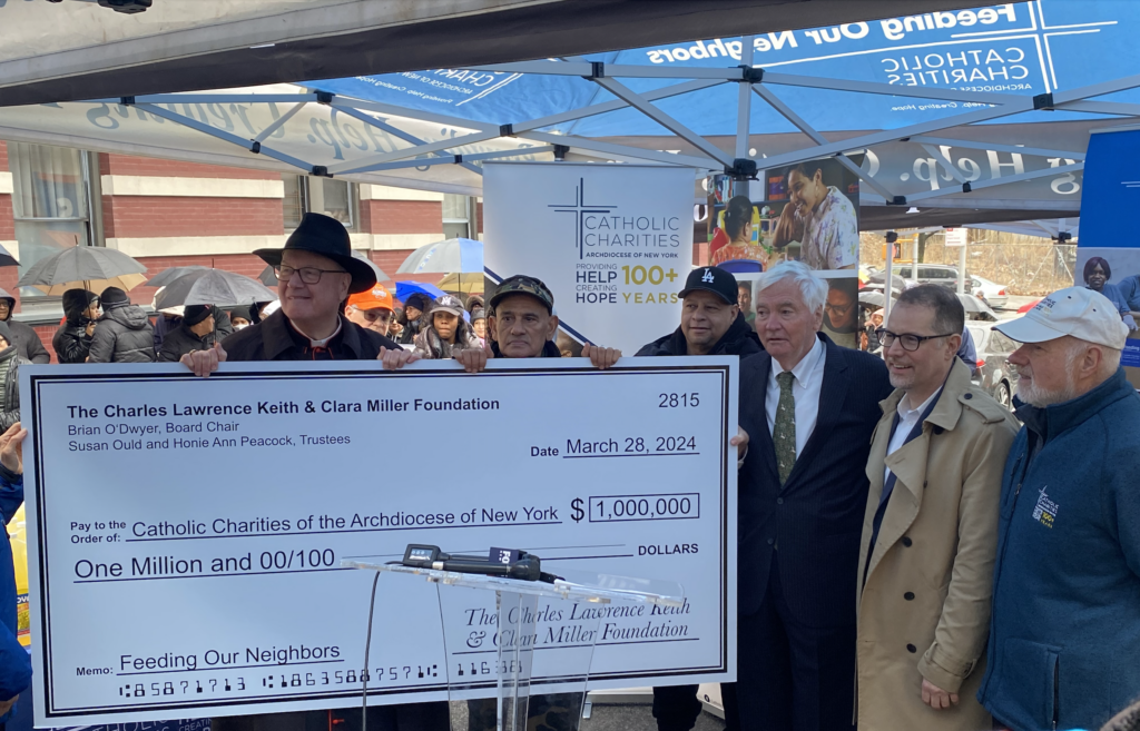 Cardinal Timothy Dolan (left, wearing black hat) received a $1 million donation on behalf of Catholic Charities of the Archdiocese of New York from the Charles Lawrence Keith and Clara Miller Foundation, represented by Brian O'Dwyer (third right).