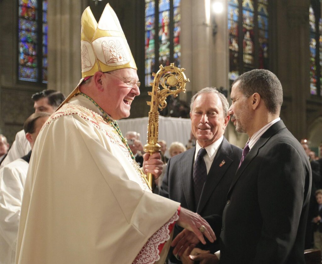 Archbishop Timothy M. Dolan greets New York City Mayor Michael Bloomberg, center, and New York Gov. David Paterson following the Mass of installation for Archbishop Dolan at St. Patrick's Cathedral in New York April 15.   (CNS photo/pool) (April 16, 2009) See DOLAN-INSTALL April 16, 2009.