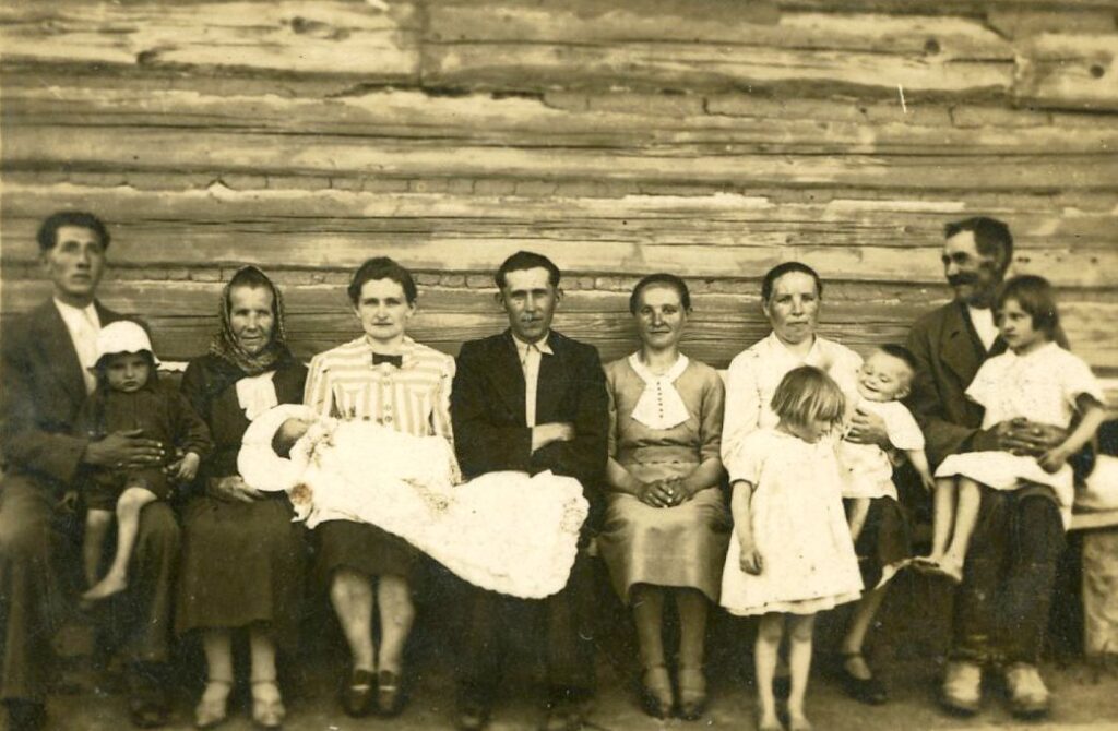 Family members gather in front of Blessed Józef and Wiktoria Ulma's house just after the baptism of Antoni Ulma in the summer of 1941.