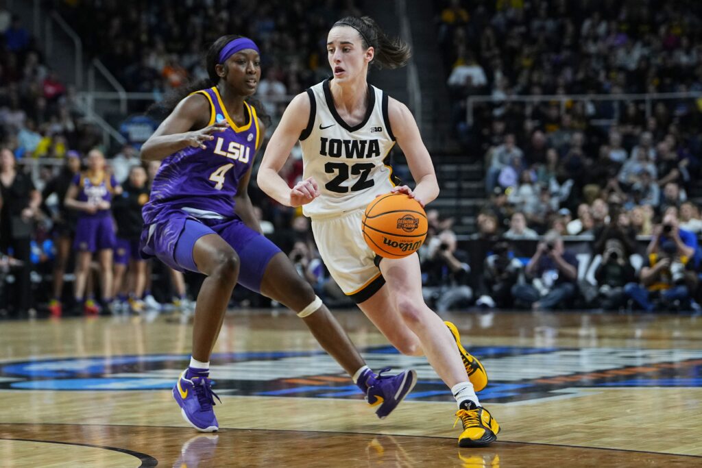 Hawkeyes guard Caitlin Clark (22) controls the ball against LSU Lady Tigers guard Flau'jae Johnson (4) in the fourth quarter of the finals of the Albany Regional of the 2024 NCAA Tournament at MVP Arena in New York April 1, 2024. Clark graduated in 2020 from Dowling Catholic High School in Des Moines, Iowa.