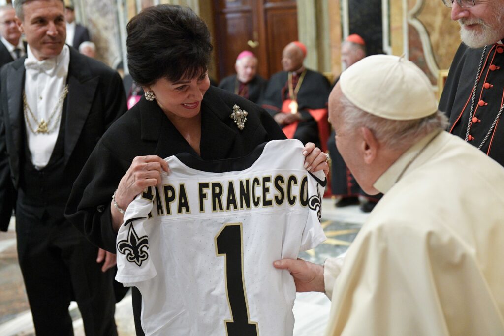 Pope Francis receives a New Orleans Saints football jersey bearing his name during a meeting with members of The Papal Foundation and their families at the Vatican April 12, 2024.