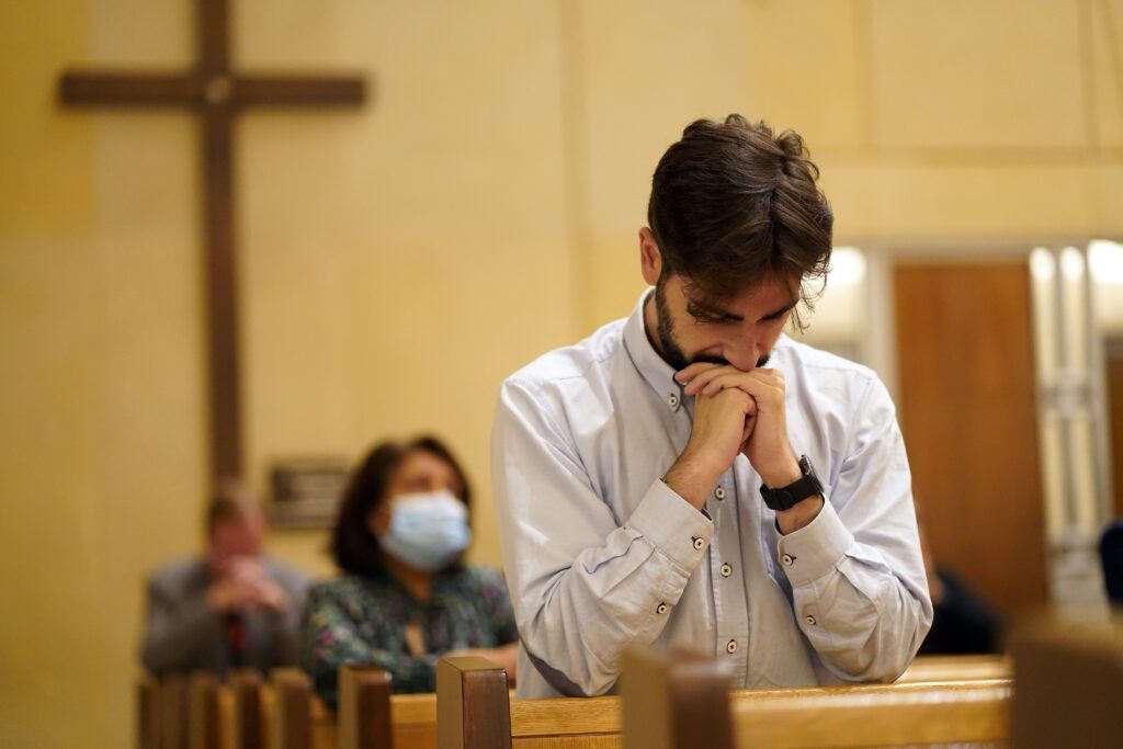 A man prays during a pontifical Mass at Holy Family Church in Manhattan September 25, 2023.