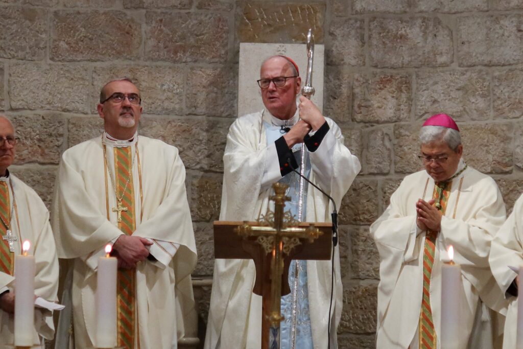 Cardinal Timothy M. Dolan of New York, center, holds his crozier during Mass at the Our Lady of Peace chapel in the Notre Dame of Jerusalem Center, a pontifical institute dedicated to ecumenical and interreligious dialogue, in Jerusalem April 13, 2024.