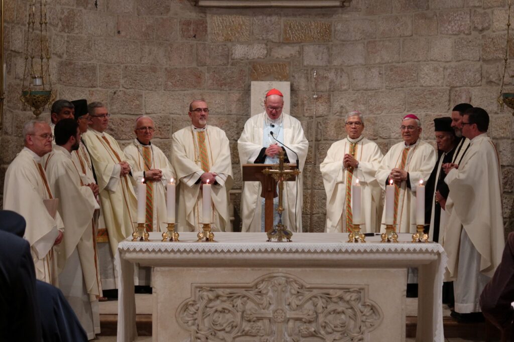 Cardinal Timothy M. Dolan of New York, center, offers Mass at the Our Lady of Peace chapel in the Notre Dame of Jerusalem Center April 13, 2024.