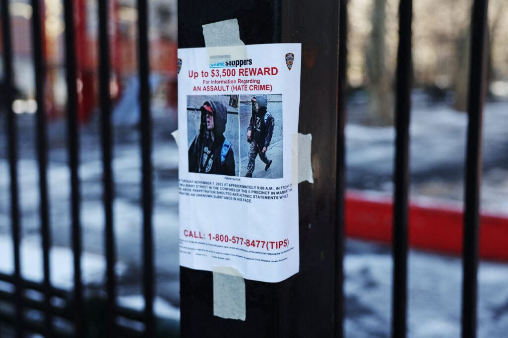 A New York City Police Department reward poster for a suspect in an alleged hate crime attack hangs from a fence in New York City's Chinatown neighborhood January 22, 2024.
