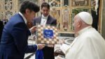Pope Francis receives a wooden checkerboard from members of the Italian Checkers Federation during a meeting at the Vatican April 26, 2024.