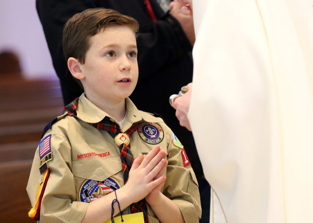 A Scout is pictured in a file photo receiving Communion during Mass while participating in Cub Scout Fun and Faith Day at St. Patrick Church in Smithtown.