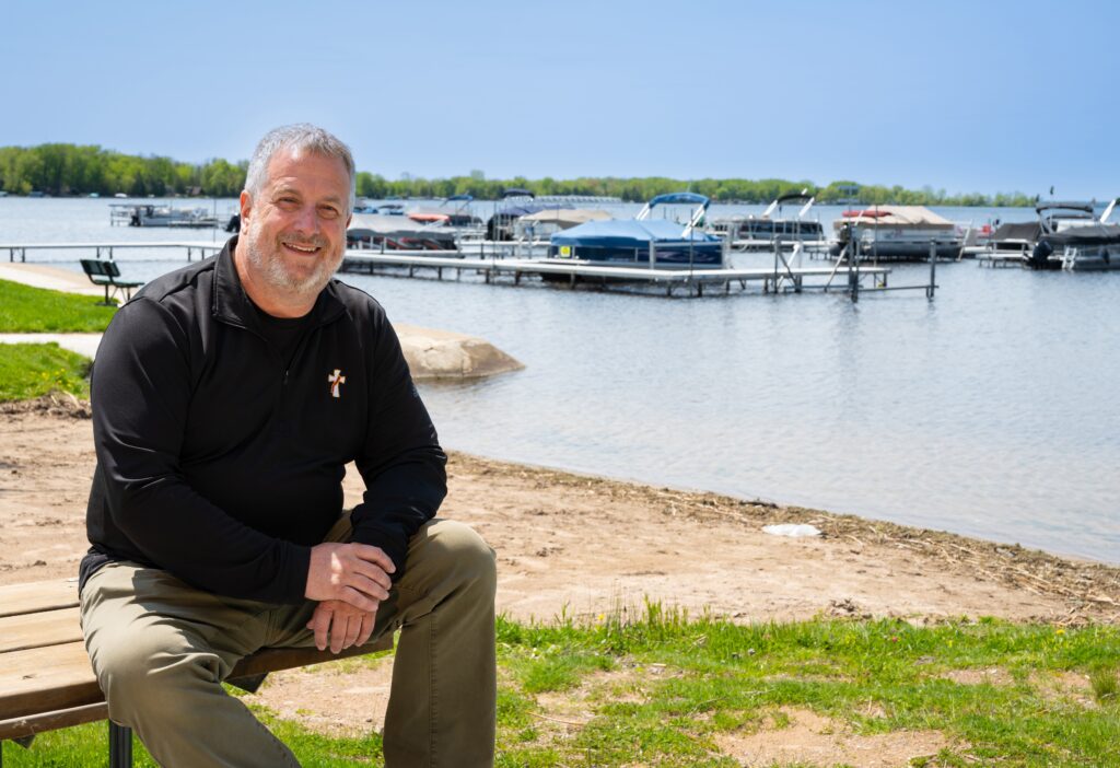 Deacon Todd Raether, pastoral coordinator at St. Martin of Tours Parish in Cecil, Wis., is pictured at the Cecil Village Park boat landing May 14. Deacon Raether is coordinating a boat procession on Shawano Lake June 12 as part of the National Eucharistic Procession's Marian Route, which travels through Wisconsin.