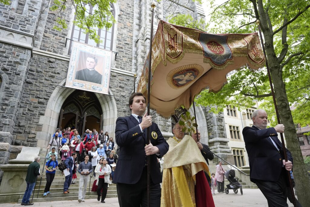 Auxiliary Bishop Juan Miguel Betancourt of Hartford, Connecticut, carries the monstrance during a Eucharistic procession outside St. Mary's Church in New Haven, Connecticut, May 19. The procession was a part of the National Eucharist Pilgrimage.