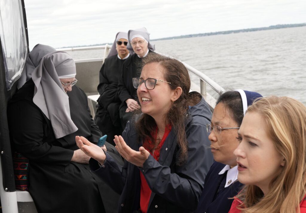 People pray as the Eucharistic travels by boat from New Haven to Bridgeport, Connecticut, on May 19, 2024, as part of the National Eucharistic Pilgrimage.