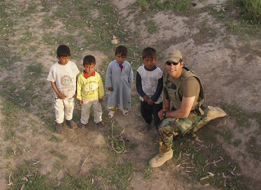 Now-Father David Santos is seen with Iraqi children during his time serving in the military in this undated photo.