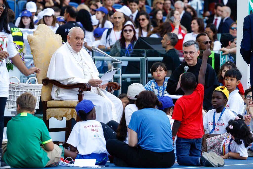 Pope Francis greets children during the first World Day of Children May 25, 2024, in Rome's Olympic Stadium.