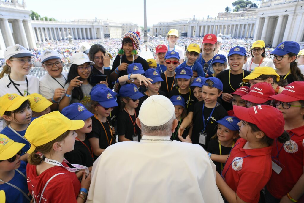 Pope Francis shakes hands and greets a group of children after Mass in St. Peter's Square at the Vatican May 26, 2024, wrapping up the first World Children's Day held May 25-26.