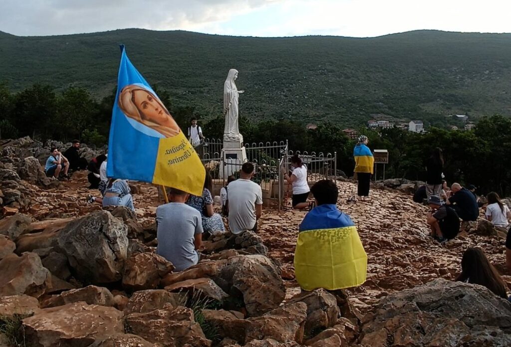 Ukrainian youth pray on Apparition Hill (Mount Podbrdo) in Medjugorje, Bosnia and Herzegovina during a May 19-27, 2024 pilgrimage for peace as Russia escalates attacks on their nation amid a war now in its 11th year.
