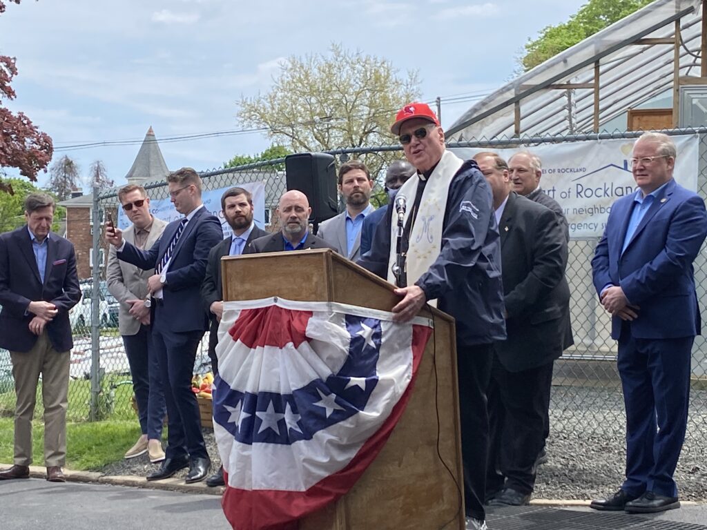 Cardinal Timothy Dolan (at podium), flanked by elected representatives from Rockland County and the Town of Haverstraw, addresses attendees at the blessing of the soil of Catholic Charities Community Services of Rockland, May 4, 2024.