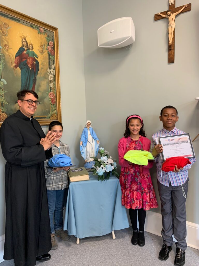 Father Arthur F. Rojas (left), pastor of Presentation-Sacred Heart Parish in Port Ewen, poses with winners of the Knights of Columbus Council #275 Catholic Citizenship Essay Contest, May 11, 2024.