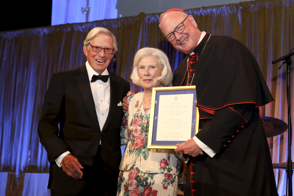 Cardinal Timothy Dolan (right), poses with Peter Grauer, president of the Inner-City Scholarship Fund and president of Bloomberg Inc. and chairman emeritus of Bloomberg, L.P.; and Ruth Woolard (center), one of Inner-City’s most dedicated donors, who received the inaugural Founders Award for Lifetime Service to the Fund.