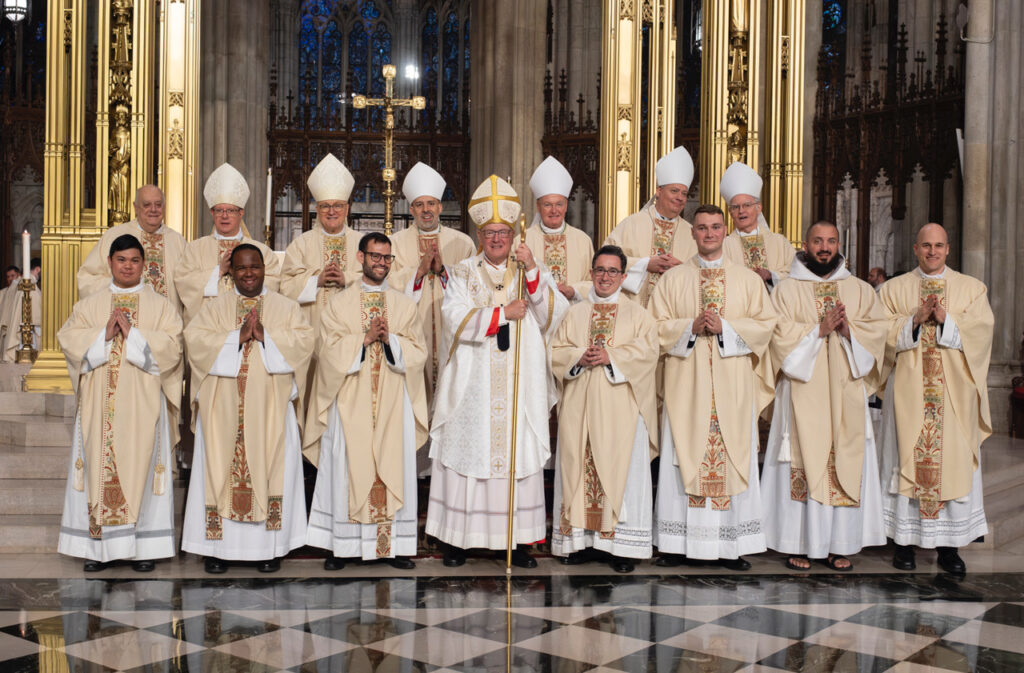 Cardinal Timothy Dolan (center) poses with the seven new priests ordained on May 25, 2024, at St. Patrick's Cathedral. In the top row, from left: Monsignor Joseph LaMorte, vicar general of the Archdiocese of New York; Auxiliary Bishop Gerardo Colacicco; Diocese of Brooklyn Auxiliary Bishop James Massa, rector of St. Joseph's Seminary; Auxiliary Bishop Joseph Espaillat; Auxiliary Bishop Edmund Whalen, vicar for clergy; Auxiliary Bishop John Bonnici; and Auxiliary Bishop Peter Byrne.