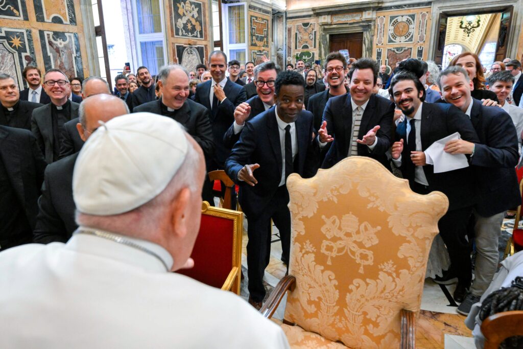 Pope Francis engages in a light-hearted moment with comedians Stephen Colbert, Chris Rock, Jimmy Fallon, and other comedians after an audience at the Vatican on June 14, 2024.