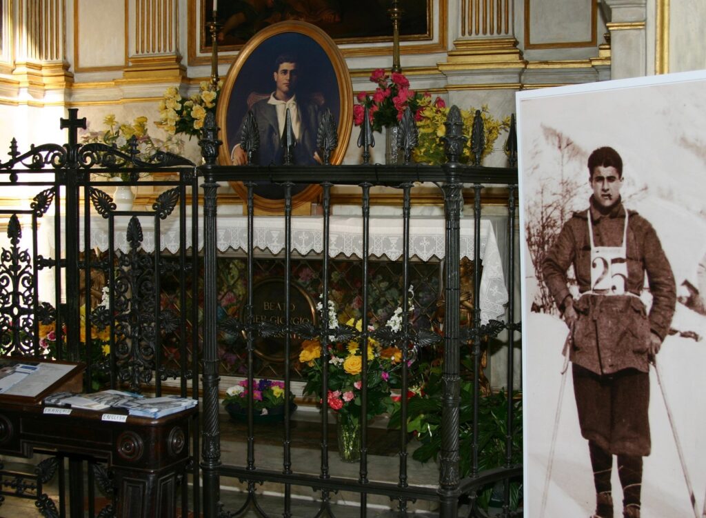 Images of Blessed Pier Giorgio Frassati appear beside and on his tomb at St. John the Baptist Cathedral in Turin, Italy, in this file photo from February 2006.