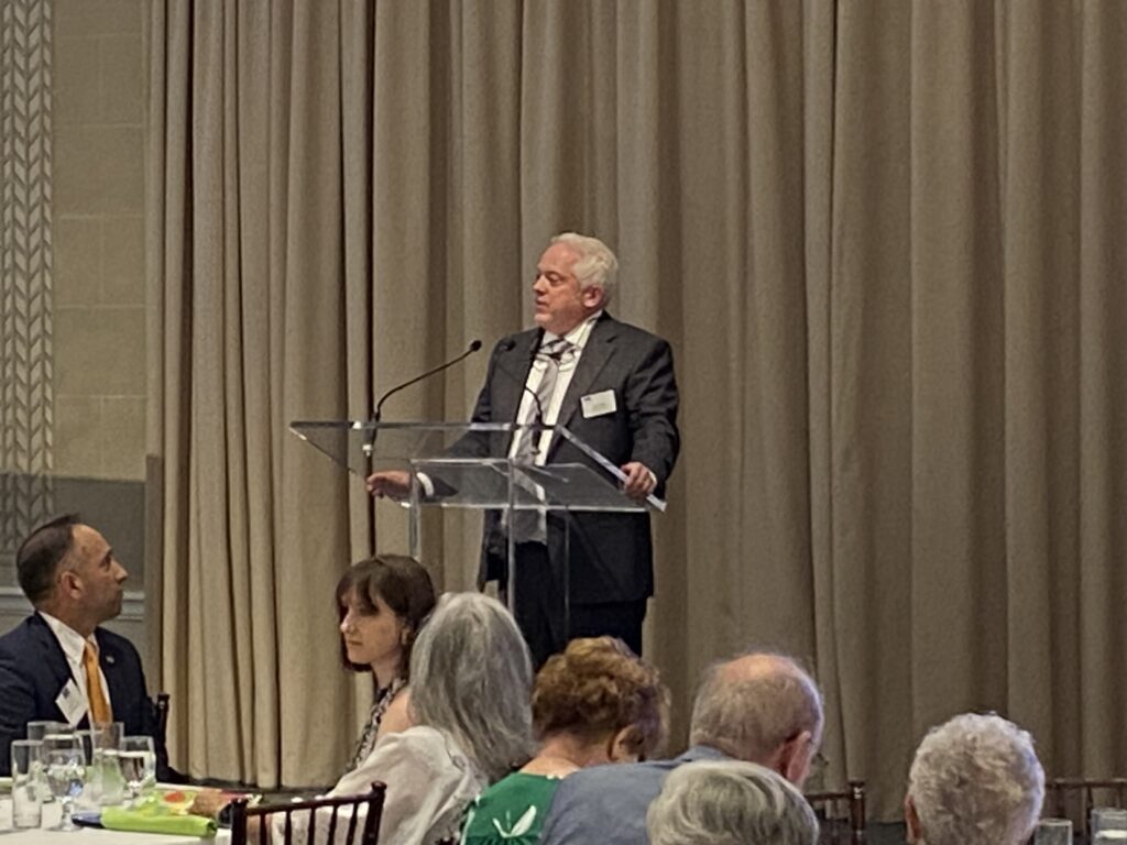 ArchCare President and CEO Scott LaRue addresses guests at a celebration of Calvary Hospital’s 125th anniversary, held June 12, 2024, at the New York Botanical Gardens.