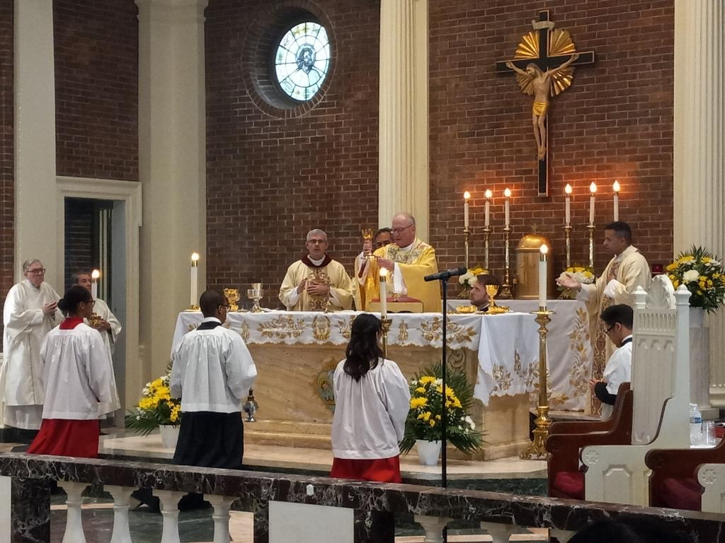 Cardinal Timothy Dolan consecrates the bread and wine during the 100th Anniversary Mass of Our Lady of Angels in the Bronx, Saturday, June 8, 2024.