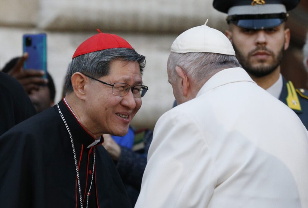 Pope Francis talks with Cardinal Luis Antonio Tagle after praying in front of a Marian statue at the Spanish Steps in Rome Dec. 8, 2022, the feast of the Immaculate Conception.