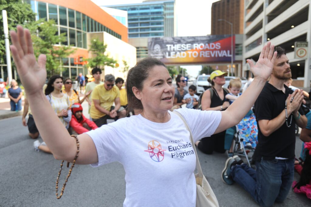 Kathy Ortiz-Jimenez of East Setauket, N.Y., who is a participant in the National Eucharistic Pilgrimage's Seton Route, prays after arriving for a Mass to welcome pilgrims at St. John the Evangelist Church in Indianapolis July 16, 2024, just ahead of the National Eucharistic Congress.